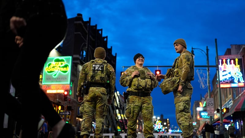 Members of the National Guard stand watch at the intersection of B.B. King Blvd. and Beale...